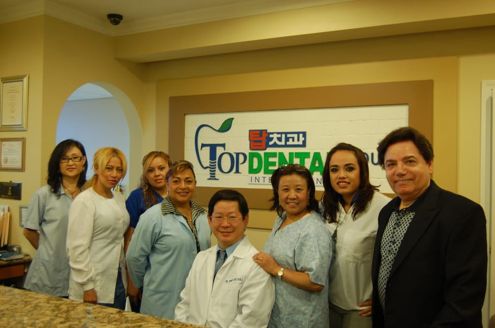 Dr. Andre Lee with the Top Implant Center team at the reception desk